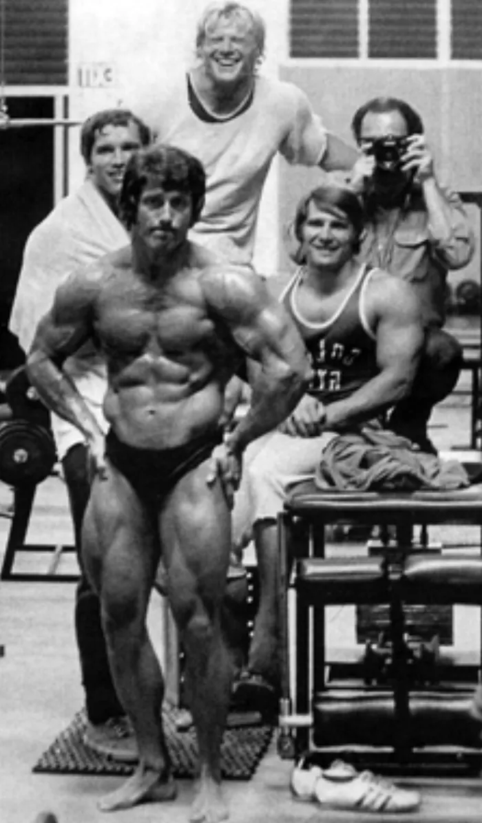 A rare candid at Gold's Gym pairs a young Frank Zane with Arnold Schwarzenegger, Dave Draper, and Zeller.