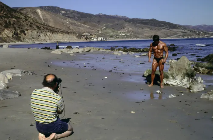 A behind-the-scenes glimpse of a photographer at work, shooting Frank on the Malibu rocks.