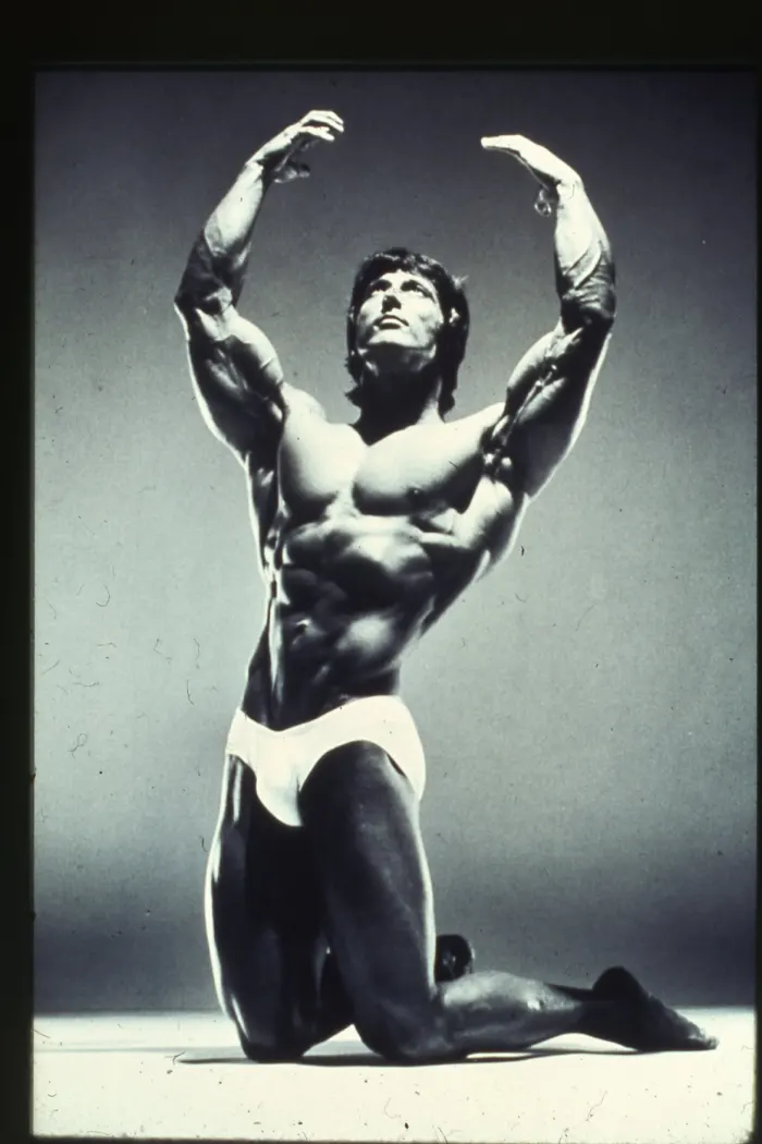 An iconic black-and-white studio 'chalice' pose, dramatic gradient lighting and near-perfect symmetry.