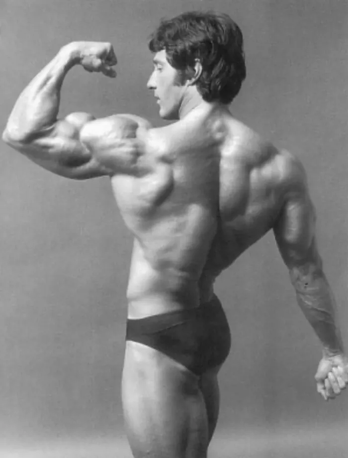 The quintessential side-chest and back-bicep pose, tack-sharp and beautifully lit.