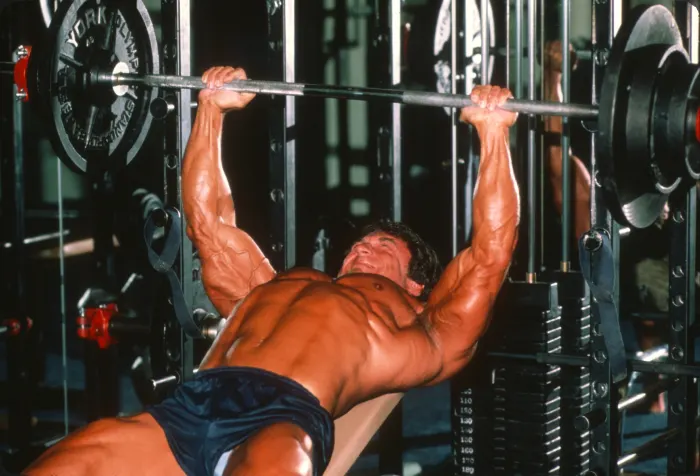 A magazine-quality color mid-incline-press shot with intense lighting and full vascularity.