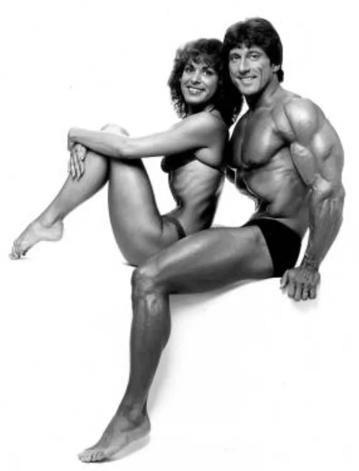 An elegant studio portrait of Frank and Christine Zane seated back-to-back.